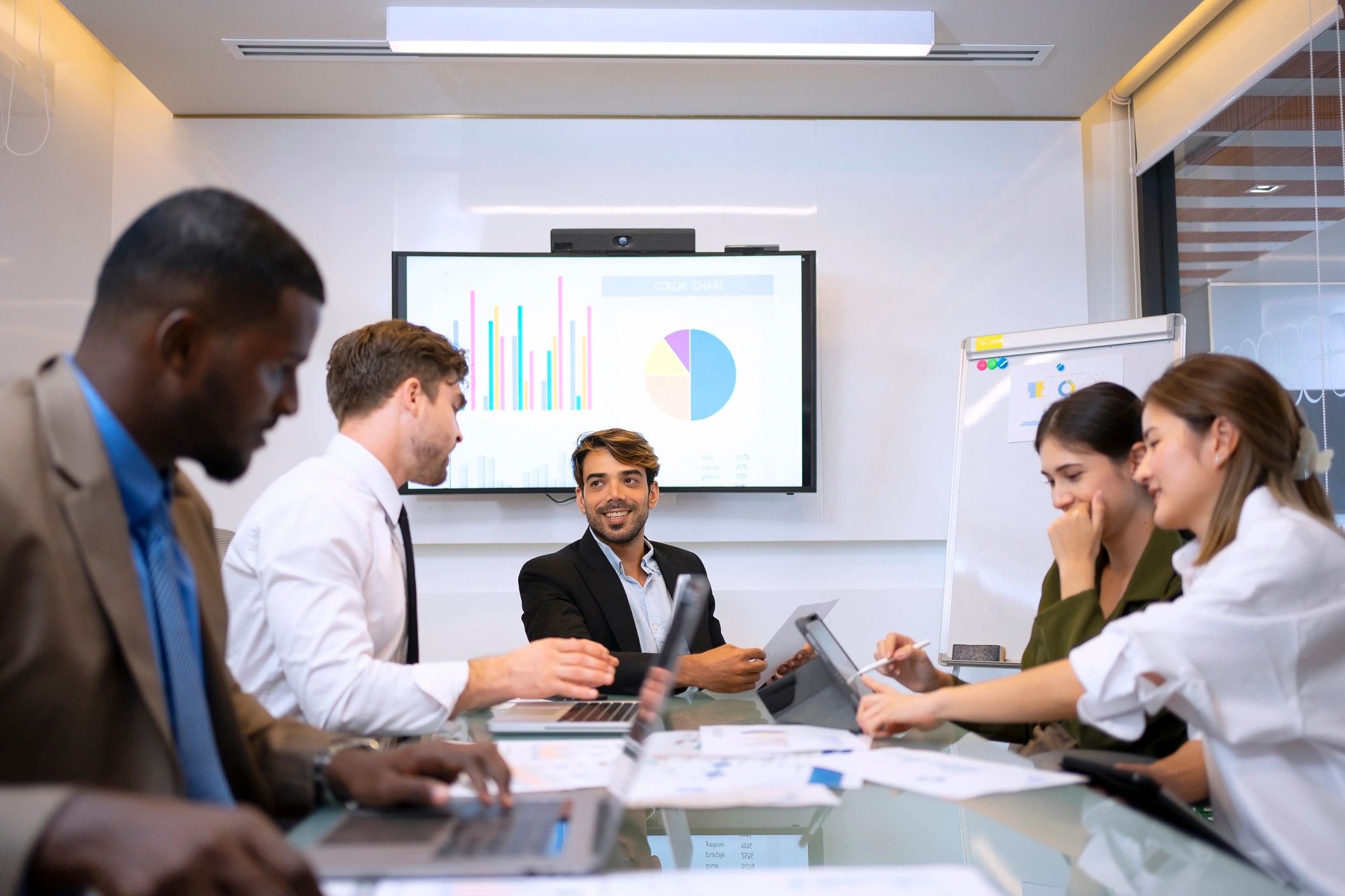 Team reviewing analytics on a laptop during an office meeting